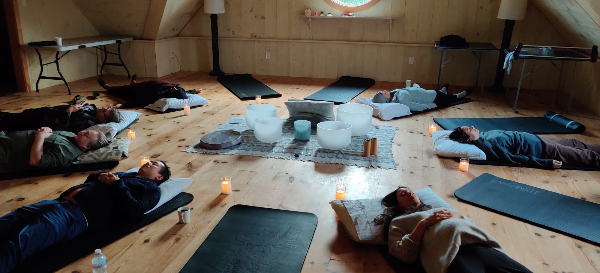 Mats and candles laid out around the bowls in a timber barn at TAS Impact's retreat